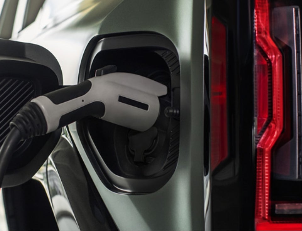 Close up of charging port with charger plugged in on a GMC Hummer EV SUV - AutoWorld GMC in Mineral Wells TX
